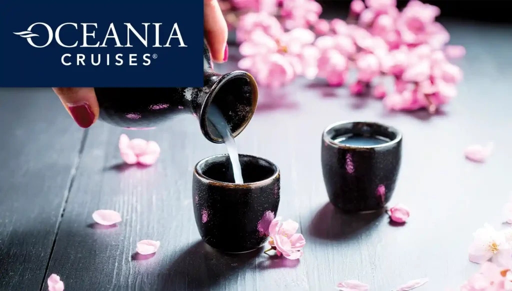 Photo of someone pouring sake (Japanese rice wine) with cherry blossoms in the background
