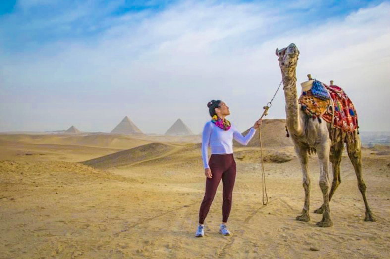 Victoria Peters McDowell - image0-CC Victoria Peters McDowell with a camel in Egypt, with the Pyramids of Giza in the background